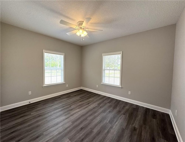 1029 N Church St, Odum, GA 31555 - unfurnished room with plenty of natural light, dark wood finished floors, ceiling fan, a textured ceiling, and baseboards