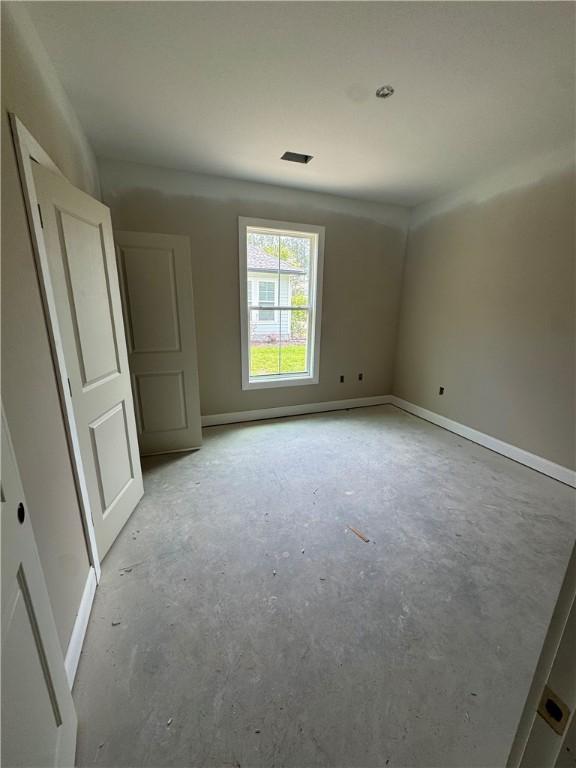 102 Bluebird Ct, Saint Marys, GA 31558 - empty room featuring unfinished concrete floors and baseboards