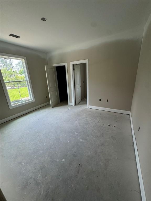 102 Bluebird Ct, Saint Marys, GA 31558 - unfurnished bedroom featuring baseboards and concrete flooring