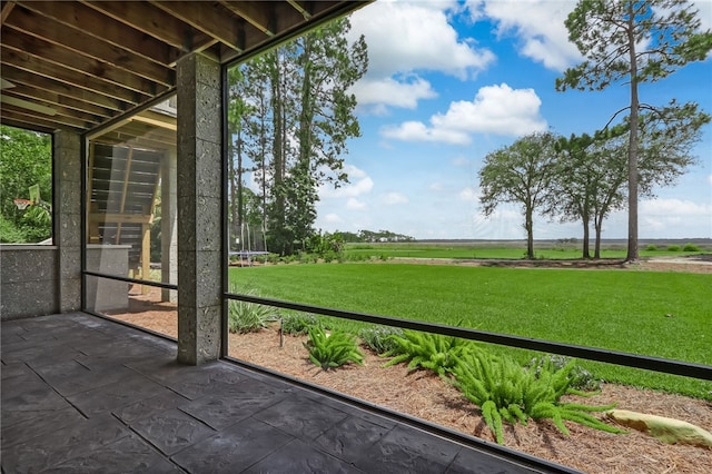 unfurnished sunroom with a rural view