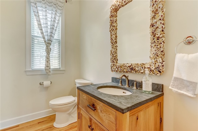 bathroom featuring vanity, hardwood / wood-style floors, and toilet