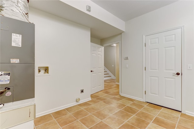 washroom featuring electric dryer hookup, washer hookup, and light tile patterned floors