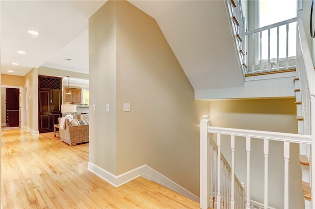 interior space with a wealth of natural light, vaulted ceiling, and hardwood / wood-style floors