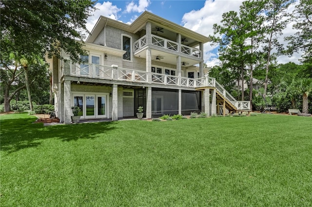 back of property featuring a yard, a balcony, and ceiling fan