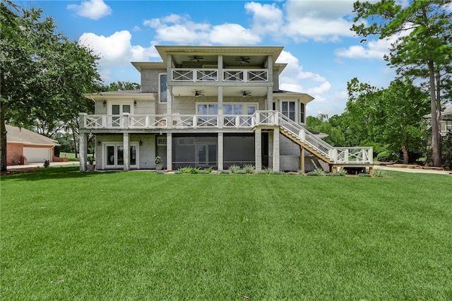 rear view of property with a balcony, a yard, ceiling fan, and french doors