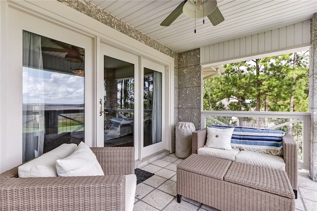 sunroom featuring ceiling fan