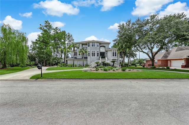 view of front of home featuring a garage and a front yard