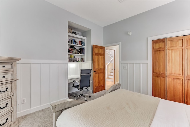 bedroom featuring light colored carpet and a closet