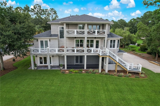 back of house with a balcony, a yard, a patio area, and french doors