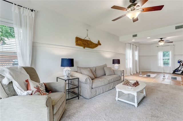 living room with tile patterned floors and ceiling fan