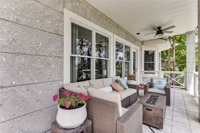 view of patio / terrace with an outdoor living space with a fire pit and ceiling fan