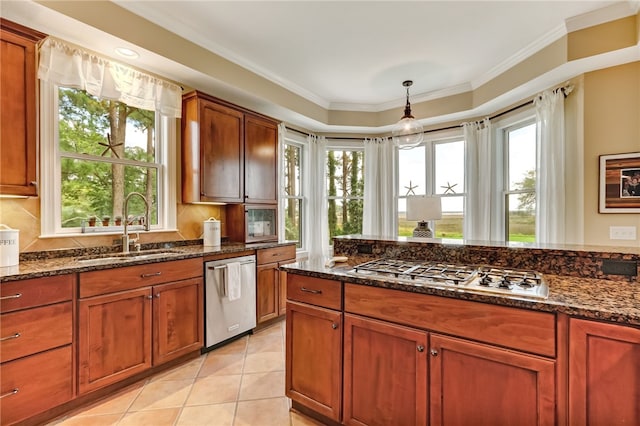 kitchen with sink, appliances with stainless steel finishes, dark stone countertops, hanging light fixtures, and plenty of natural light