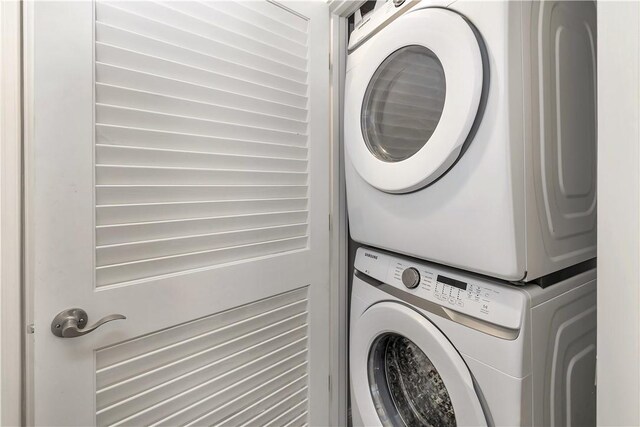 laundry area with stacked washer / dryer