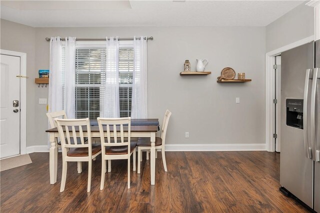 dining area featuring dark hardwood / wood-style floors