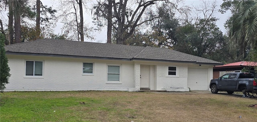 510 Nottingham Dr, Brunswick, GA 31525 - ranch-style home with a garage, brick siding, a front yard, and roof with shingles