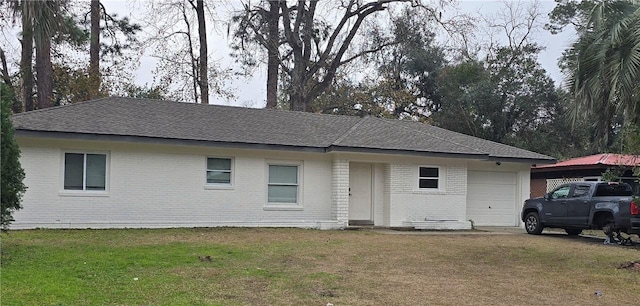 510 Nottingham Dr, Brunswick, GA 31525 - ranch-style home with a garage, brick siding, a front yard, and roof with shingles