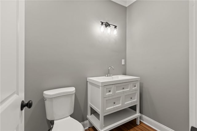 bathroom featuring hardwood / wood-style floors, vanity, and toilet