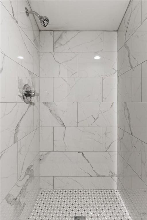 bathroom with a tile shower