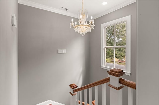 stairs featuring plenty of natural light, crown molding, and a chandelier