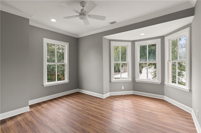 unfurnished room with ceiling fan, a healthy amount of sunlight, and wood-type flooring