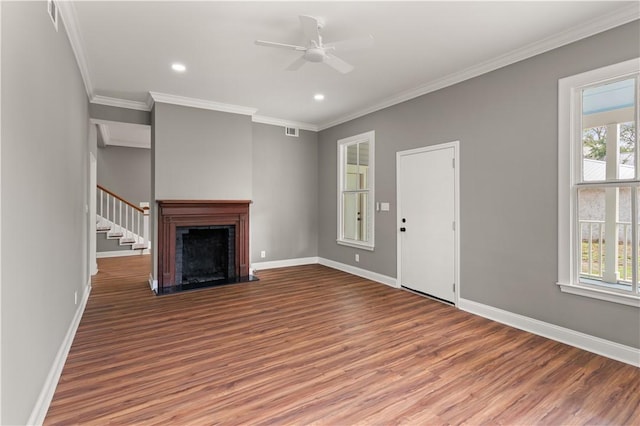 unfurnished living room with hardwood / wood-style flooring, a wealth of natural light, ornamental molding, and ceiling fan