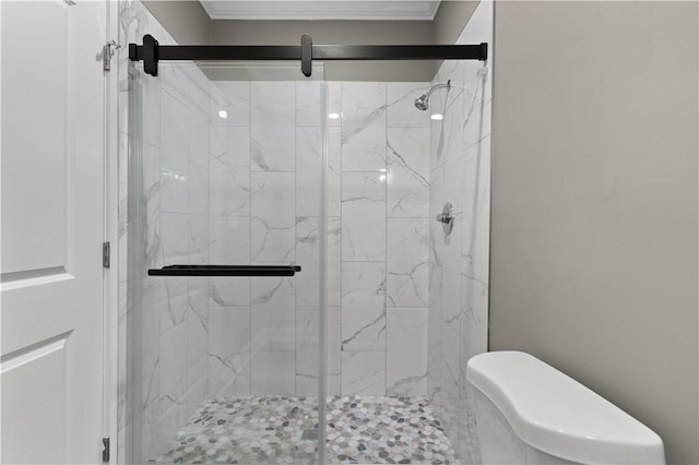 bathroom with toilet, a shower with door, and ornamental molding