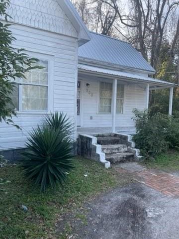 322 Archer St, Waycross, GA 31501 - doorway to property with metal roof and covered porch