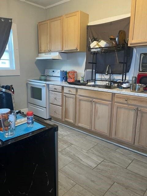322 Archer St, Waycross, GA 31501 - kitchen with light brown cabinets, white electric range oven, a sink, and under cabinet range hood