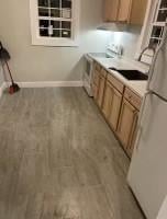 322 Archer St, Waycross, GA 31501 - kitchen featuring baseboards, light countertops, and freestanding refrigerator