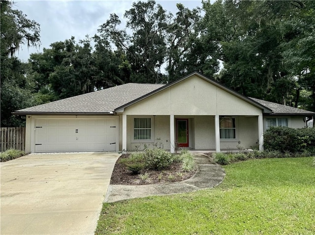 single story home with a garage, driveway, a front lawn, a porch, and stucco siding