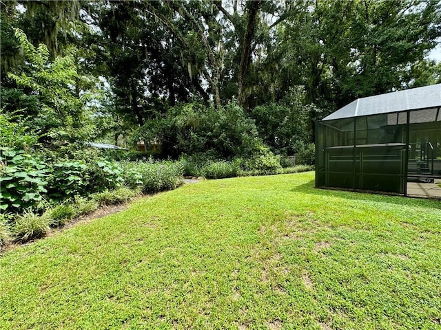 view of yard with glass enclosure