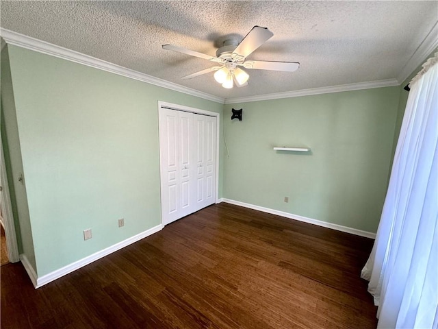 unfurnished bedroom with a textured ceiling, wood finished floors, baseboards, ornamental molding, and a closet