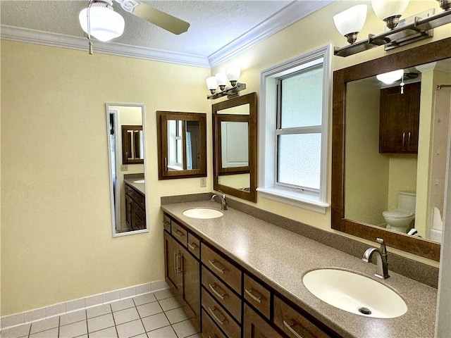 bathroom with tile patterned flooring, a sink, toilet, and crown molding