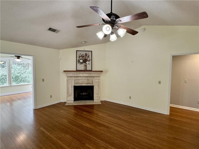 unfurnished living room with wood finished floors, visible vents, vaulted ceiling, and a premium fireplace