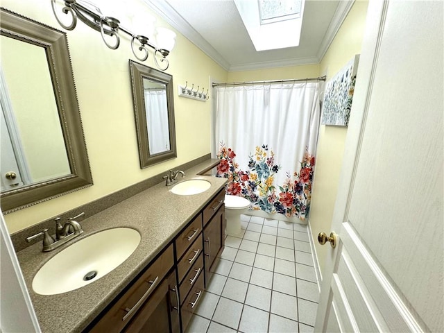 bathroom with ornamental molding, a skylight, a sink, and toilet