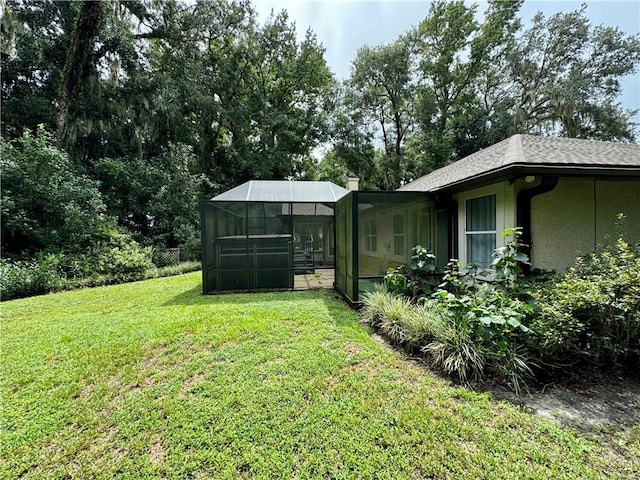 view of yard featuring glass enclosure