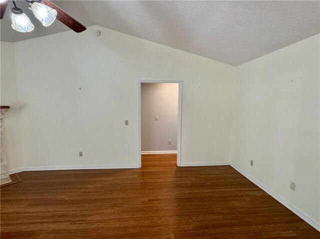 unfurnished living room with vaulted ceiling, a fireplace, wood finished floors, and a ceiling fan