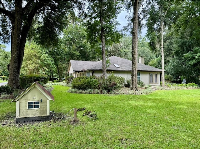 view of home's exterior with a yard and a chimney