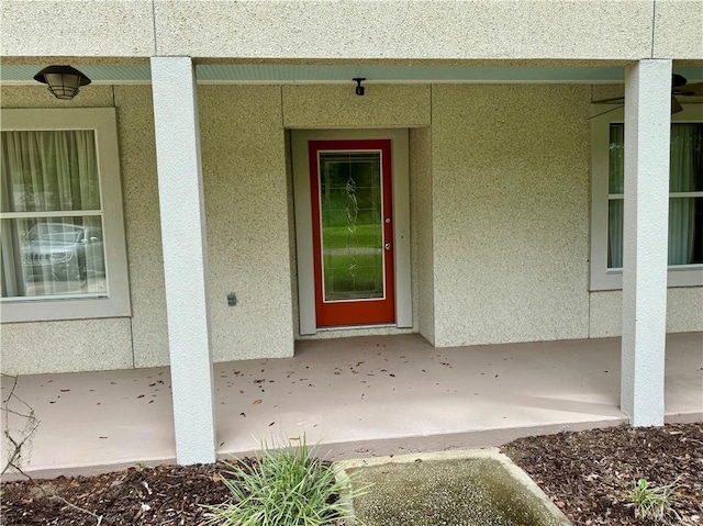 property entrance featuring stucco siding