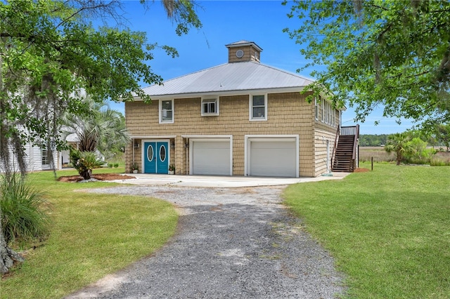 view of front facade with a garage and a front lawn