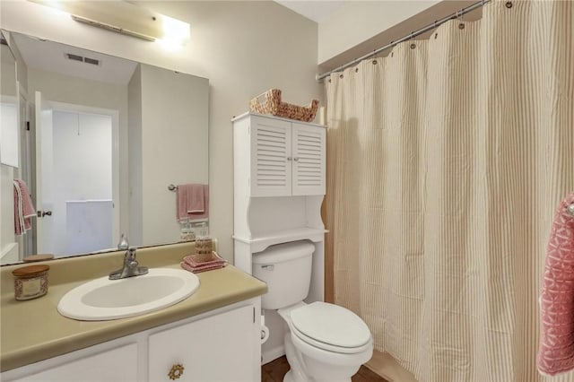 bathroom with visible vents, toilet, vanity, and a shower with shower curtain