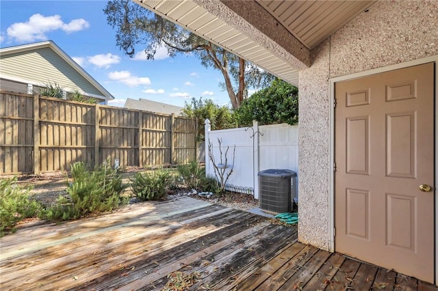 wooden terrace with cooling unit and fence