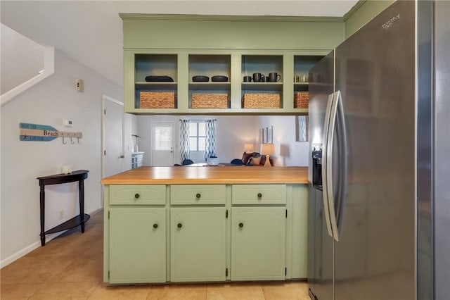 kitchen featuring green cabinetry, open shelves, light tile patterned flooring, and stainless steel fridge with ice dispenser