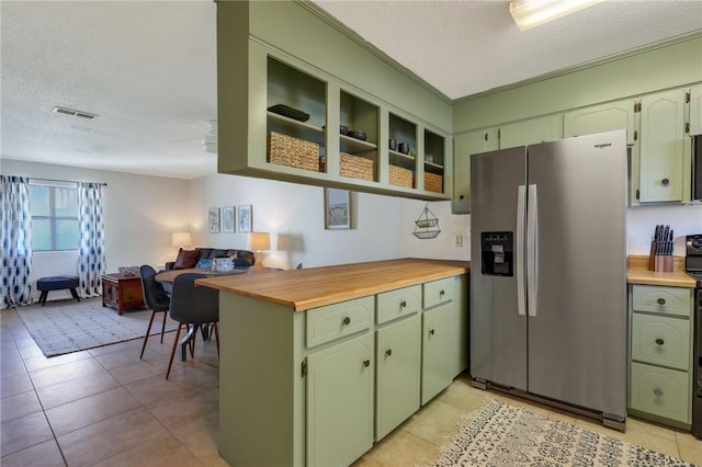 kitchen featuring visible vents, light tile patterned floors, stainless steel refrigerator with ice dispenser, a textured ceiling, and green cabinetry