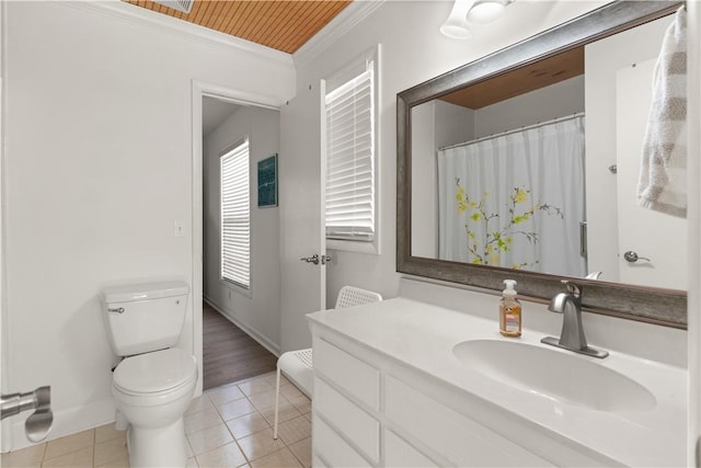 full bath featuring toilet, vanity, baseboards, tile patterned floors, and crown molding