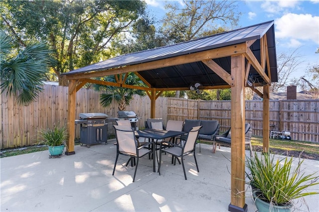 view of patio / terrace featuring a gazebo, outdoor dining area, grilling area, and a fenced backyard