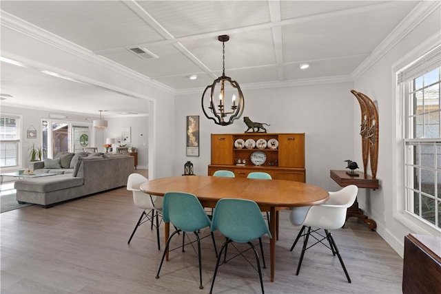 dining space featuring light wood-type flooring, coffered ceiling, visible vents, and crown molding