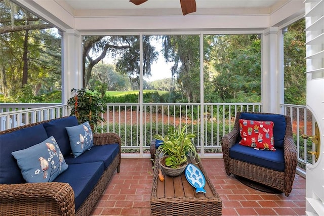 sunroom with a wealth of natural light and ceiling fan