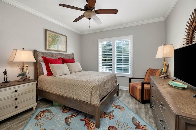 bedroom featuring ceiling fan, ornamental molding, and light wood-type flooring