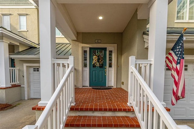 property entrance with a porch and a garage